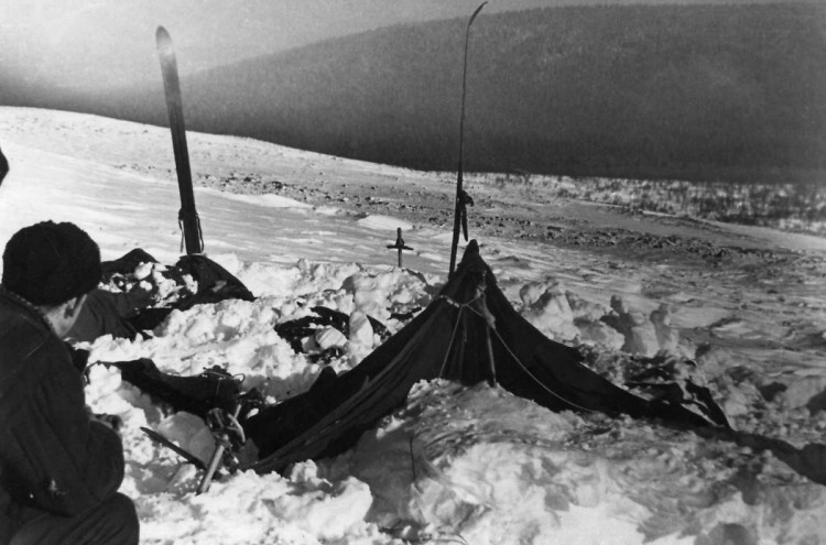 Dyatlov Pass: The tent partly cleared of the snow, 27 Feb 1959 - Yuri Koptelov in the frame, photo by V. Brusnitsyn