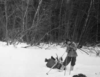 28 Jan 1959 - Lozva river, Nikolayi is cleaning his skis with a knife.