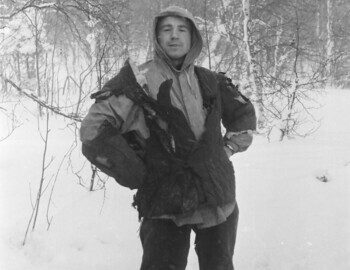 Slobodin in a burned quilted jacket. An ice ax is visible at his feet (loose frame). Feb 1.