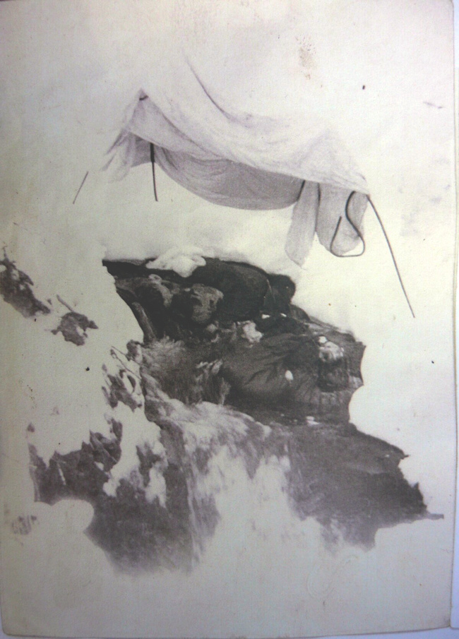 Tarpaulin over the corpses.