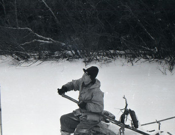 28 Jan 1959 - Lozva river, Nikolay Thibeaux-Brignolle sits on a log and cuts a long walking stick. 
