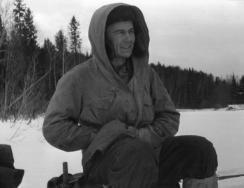 29 Jan 1959 - Lozva river, Break on Lozva. It's cold. Yuri Doroshenko listens to a conversation and smiles.