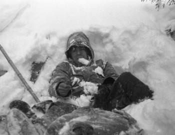 31 Jan 1959 - Auspiya river, Nikolay cleared himself of some snow and puts a black glove on his left hand. Apparently it was his turn to pack the snow ahead of the group.