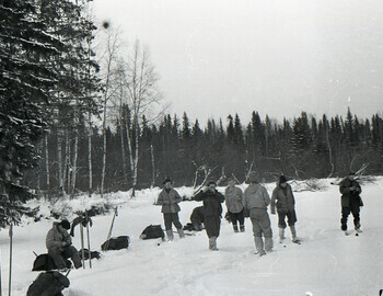 Nikolay gave his camera to Zina Kolmogorova, and she makes a photo of Rustem Slobodin.