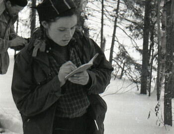 Zina Kolmogorova copies in her notebook the Mansi signs on the tree.