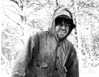 Nikolay smiles at the photographer, although it's clear he is very cold.