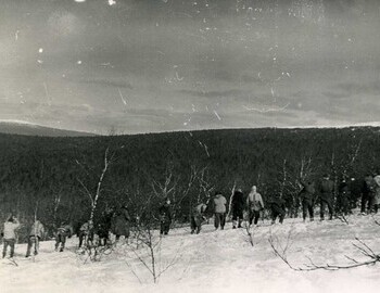 A group of hikers in search. In the center - Krylov (in overalls)