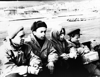 According to Askinadzi, the group travels by truck to a military helicopter parked in the far corner of the airfield. From left to right: Askinadzi-Suvorov-Mohov-Kuznetsov (with a box of butter)