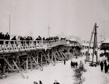 1963 - People on the bridge watching a hockey game taking place on the ice of the river. Photo by Anatoliy Fyodorovich Limansky