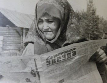 Suevat-paul. Nina Ilinichna Kurikova (Bahtiyarova) is reading the newspaper. In the background is the store.