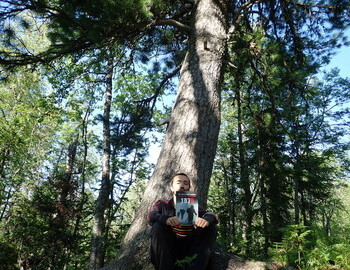 Evgeniy Kuk at the cedar with book "1079"
