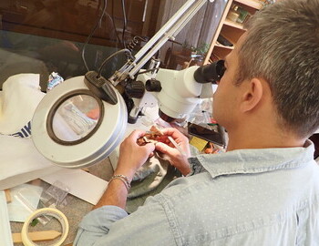 Experts Yoan Donev proceeding with the microscopic analysis of the artifact.