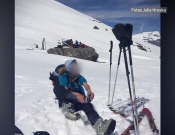 Gabriella taking off her ski boot to massage her foot.