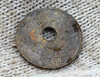 1 ruble holed coin from 2006 found at the site of the tent. (back)