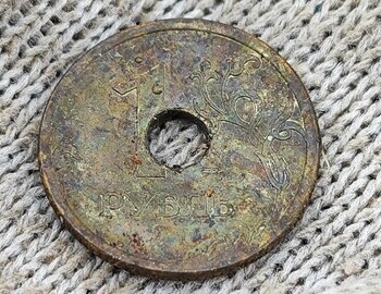 1 ruble holed coin from 2006 found at the site of the tent. (front)