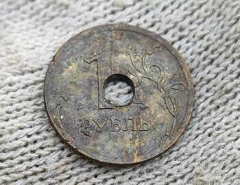 1 ruble holed coin from 2008 found at the site of the tent. (front)