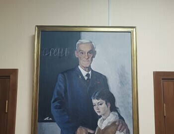 Portrait of Ivan Uvarov with a Mansi girl, on the blackboard behind him it says "Autumn"